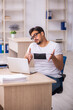 © Elnur - Young male student employee working at workplace during pandemic