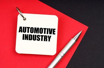 Aufkleber - On a black and red background lies a pen and a notebook with the inscription - Automotive Industry