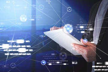 Poster - Businessman wearing formal suit is typing message on tablet