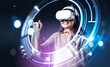 © ImageFlow - Smiling businesswoman in green sweater wearing vr helmet