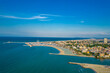 Aerial photo of the coastline and canal of the resort of Rimini on a sunny day