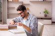 © Elnur - Young male student preparing for exams at home