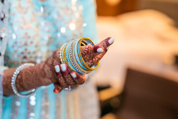 Indian bride's wearing her wedding bangles hands close up