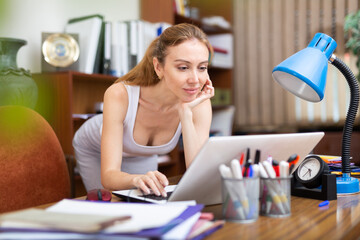 Portrait of a young sexy woman business manager working at a computer in the office of a large company