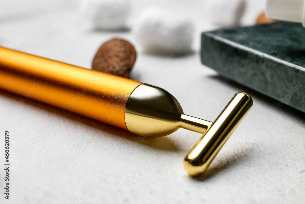 Facial massage tool on light background, closeup