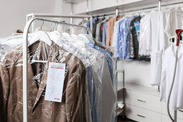 Poster - Rack with clothes at modern dry-cleaner's