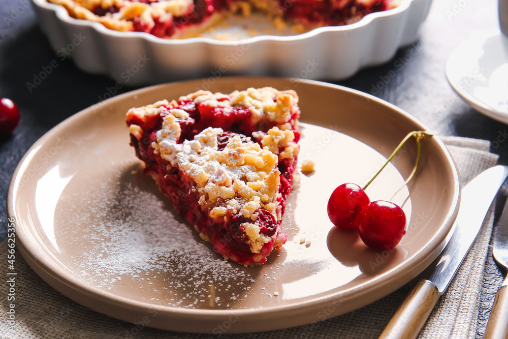 Plate with piece of tasty cherry pie on table, closeup