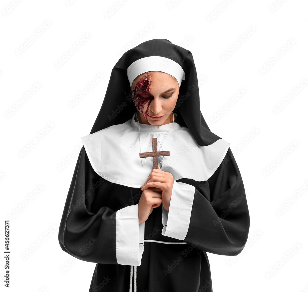 Woman dressed for Halloween as nun on white background