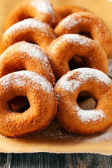 Wall Mural - Homemade donuts  with powdered sugar on a wooden baclground