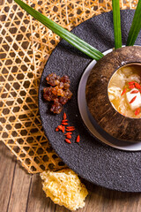 luxury braised stew hashima sweet soup with Chinese herbal in coconut bowl on wood table asian halal menu