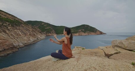 Wall Mural - Woman go yoga and sit on the rock at countryside