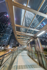 Poster - pedestrian walkway and skyscraper in Hong Kong city at night