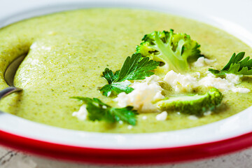 Wall Mural - Broccoli soup puree with feta cheese in plate, close-up. Cooking healthy food concept.