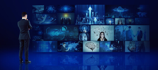 Wall Mural - Young european businessman looking at media picture gallery. Digital multimedia concept.