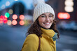 © Rido - Smiling woman on street during winter dusk