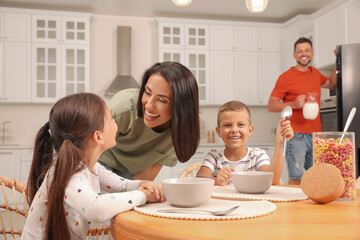 Canvas Print - Happy family with children having fun during breakfast at home