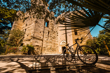 Wall Mural - Bicycle parked in front of the Maguelone Cathedral; Villeneuve-les-Maguelone in summer, France