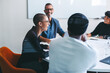 © Jacob Lund - Happy businesspeople smiling in a meeting