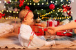 © Syda Productions - holidays and childhood concept - mother giving christmas gift to little baby girl at home