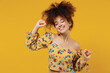 © ViDi Studio - Young happy relaxed beautiful caucasian woman 20s with culry hair in casual clothes dancing have fun at party close eyes isolated on plain yellow background studio portrait People lifestyle concept.