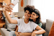 © (JLco) Julia Amaral - Romantic lesbian couple taking a selfie at home