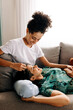 © (JLco) Julia Amaral - Happy female lovers relaxing together at home