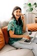 © (JLco) Julia Amaral - Woman closing business deals from her couch