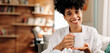 © (JLco) Julia Amaral - Cheerful young woman having coffee in the morning at home
