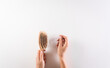 © Siam - Healthcare problem concept. Woman hand holding hair loss or hair fall in comb on white background.