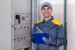 © Minerva Studio - Friendly electrician writing a document