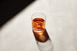 Glass of elegant straight or neat whiskey on a bar counter with dark moody atmosphere. Drink art