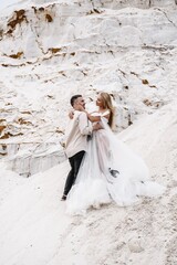 Wall Mural - Beautiful wedding couple bride and groom at wedding day outdoors at ocean beach. Happy marriage couple o