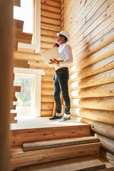 Wall Mural - Construction person on stair flight having a phone discussion