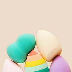 Wall Mural - Colored cosmetic beauty blender sponges Green, violet, pink, rainbow colored sponges different shape.