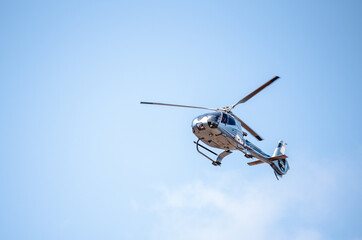 flying helicopter in blue sunny sky