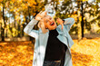 © alones - Funny beautiful young girl with cheerful emotions in fashionable autumn clothes walking and relaxing in a golden park