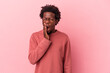 Young african american man isolated on pink background yawning showing a tired gesture covering mouth with hand.
