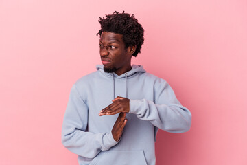 Wall Mural - Young african american man isolated on pink background showing a timeout gesture.