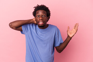 Wall Mural - Young african american man isolated on pink background screaming with rage.