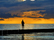 Fisherman catching fish at sunset baltic sea
