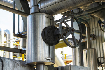 Wall Mural - The valve is a gate valve on a metal pipe at a liquefied gas production plant.