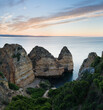 Sunny day in the Beach at Algarve, Portugal with turquoise sea in background. Bird eye view of the cliffs of Algarve. Aerial view. Concept for travel in Portugal and most beautiful places in Portugal.