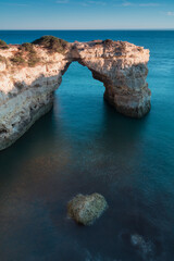 Wall Mural - Sunny day in the Beach at Algarve, Portugal with turquoise sea in background. Bird eye view of the cliffs of Algarve. Aerial view. Concept for travel in Portugal and most beautiful places in Portugal.