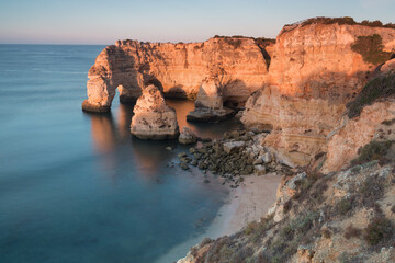 Wall Mural - Sunny day in the Beach at Algarve, Portugal with turquoise sea in background. Bird eye view of the cliffs of Algarve. Aerial view. Concept for travel in Portugal and most beautiful places in Portugal.