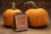 Hello October Welcome Note  - Handwriting In A Desktop Calendar With Pumpkins, Fall Season Concept