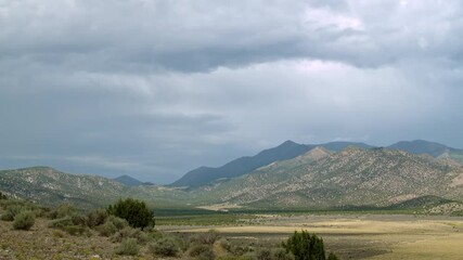 Wall Mural - Time-lapse looking up towards Flat Top Mountain in Utah as clouds move through the sky.