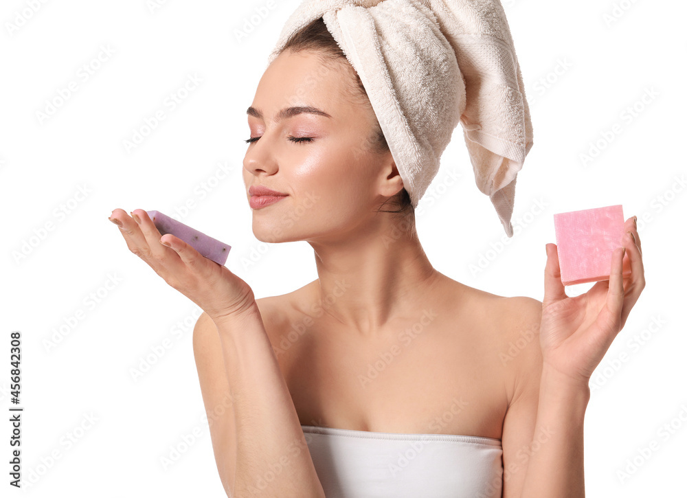 Beautiful young woman with soap on white background