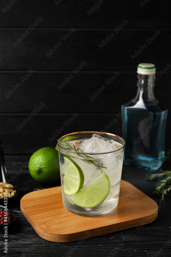 Glass of cold gin and tonic on dark background