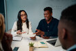 © StratfordProductions - Multiethnic young man and woman having meeting at desk discussing the project in office