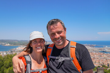 couple woman and man happy taking selfie phone self portrait smartphone camera with fun on beach coast in sete city france background